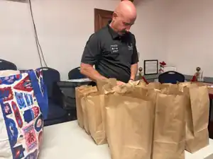 Shawn McConnell helping prepare sack lunches
